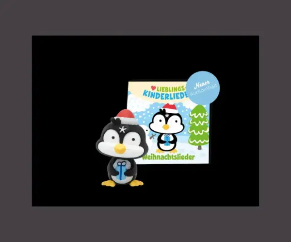 eine Pinguin Tonies Figur mit roter Mütze und blauem Geschenk zwischen den Flossen, darauf gespeichert sind Weihnachtslieder